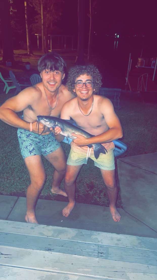 A picture of my buddy and I at Lake Murray holding a catfish